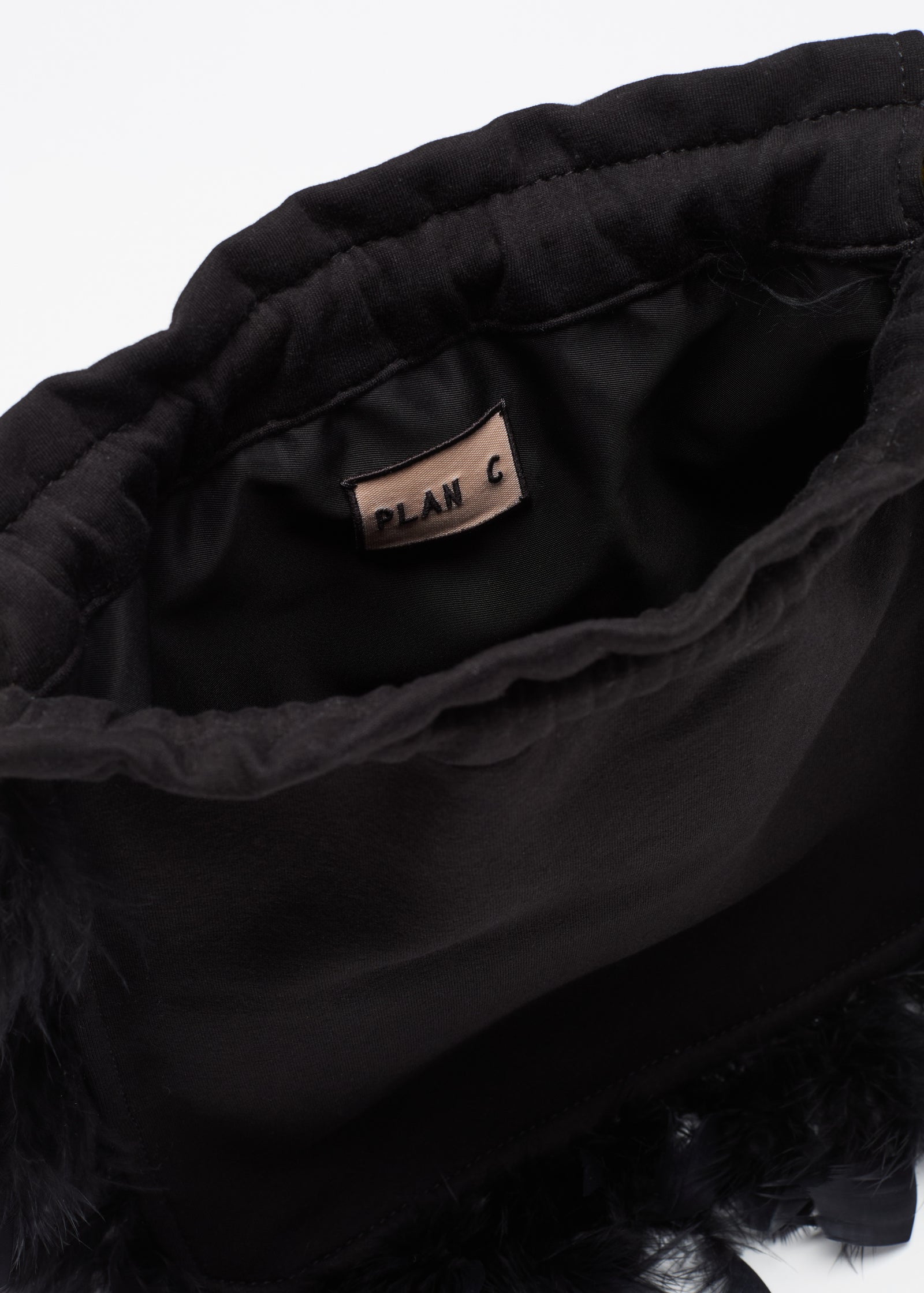 BLACK FLEECE POUCH WITH FEATHERS